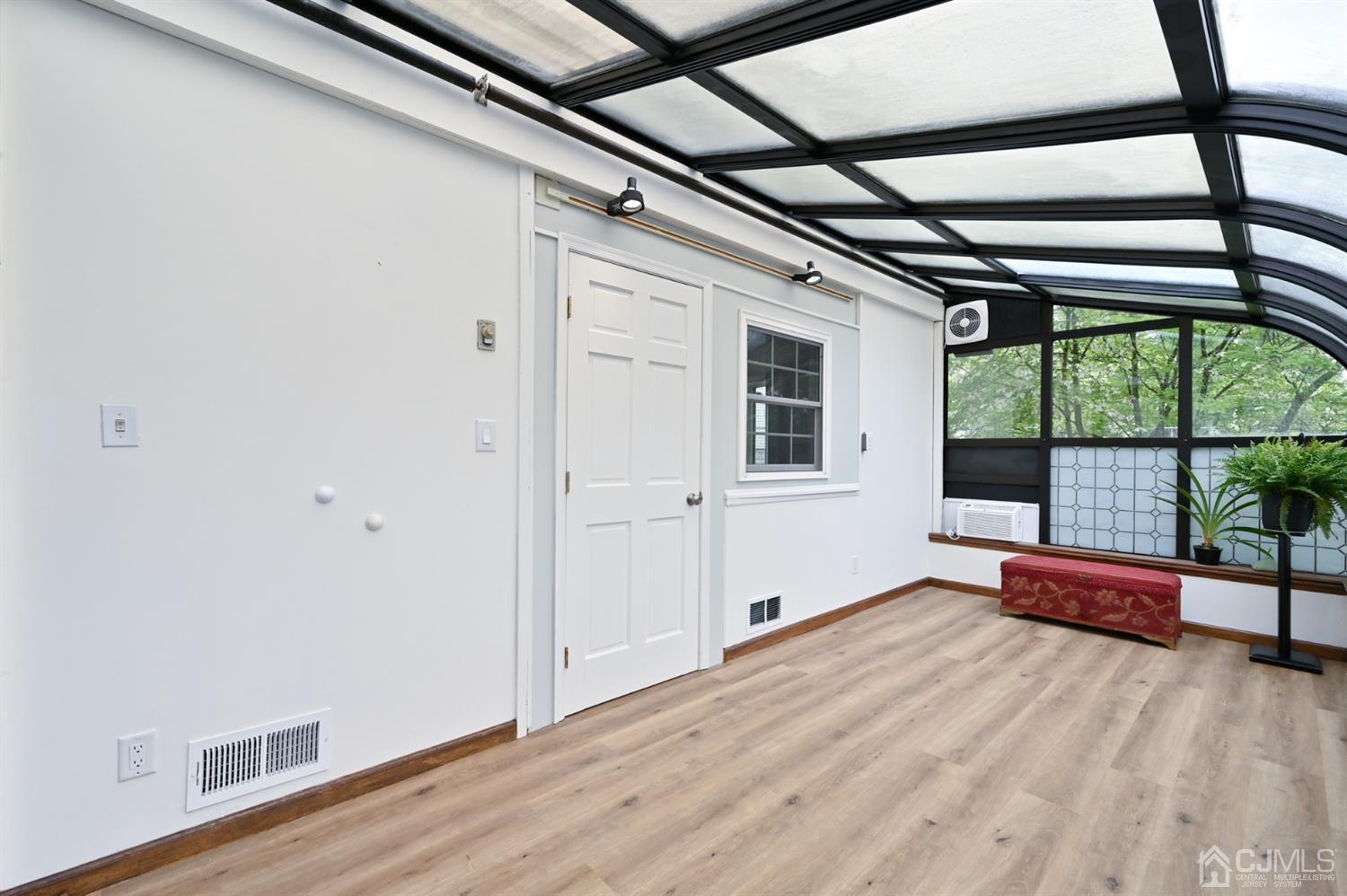 383 Paterson Avenue East Rutherford, NJ 07073 - Photo 10 of 21 a view of empty room with wooden floor and fan