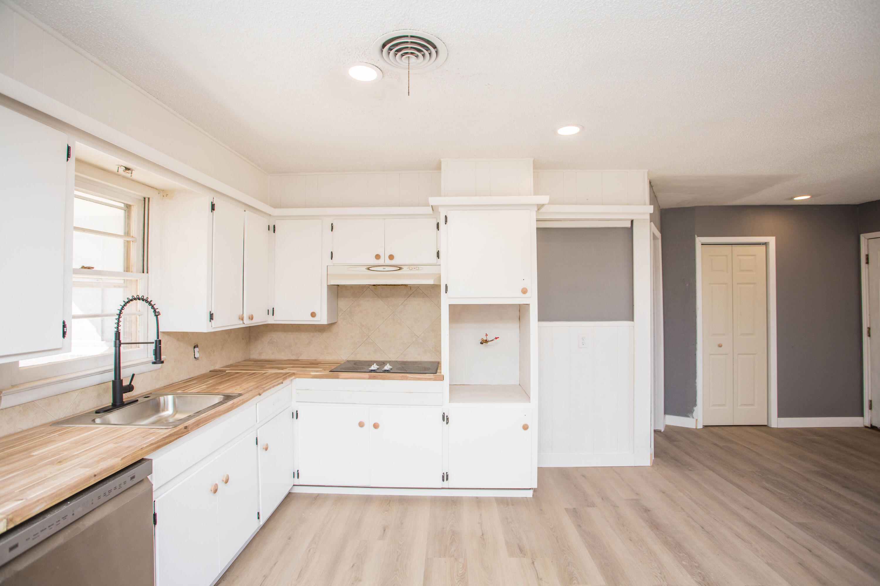 5212 41st Street Lubbock, TX 79414 - Photo 11 of 35 a view of a kitchen with wooden floor