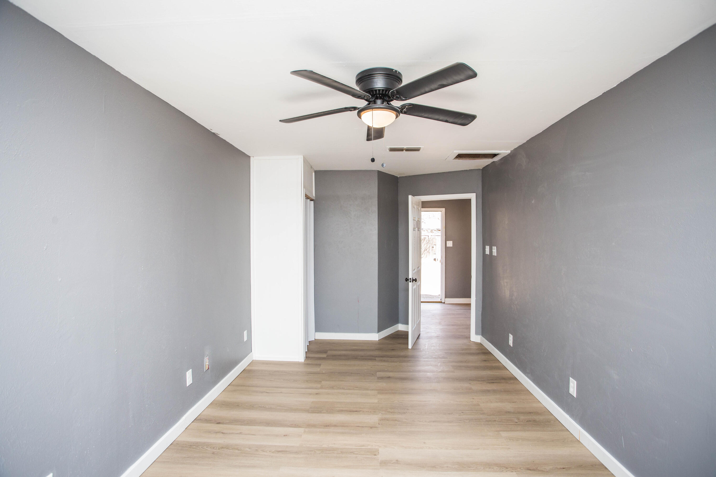 5212 41st Street Lubbock, TX 79414 - Photo 17 of 35 a view of hallway with wooden floor and ceiling fan