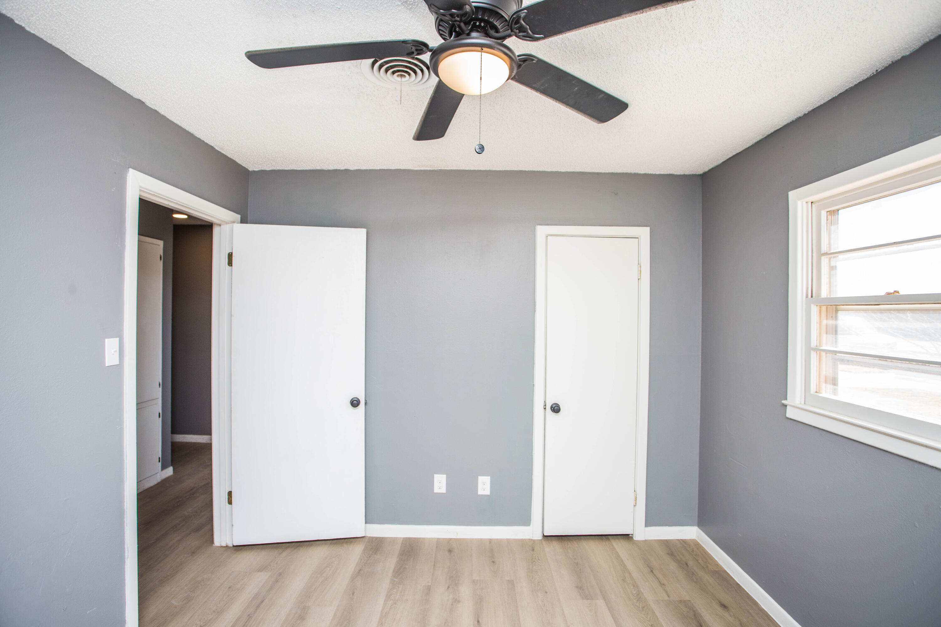 5212 41st Street Lubbock, TX 79414 - Photo 20 of 35 a view of an empty room with window and wooden floor