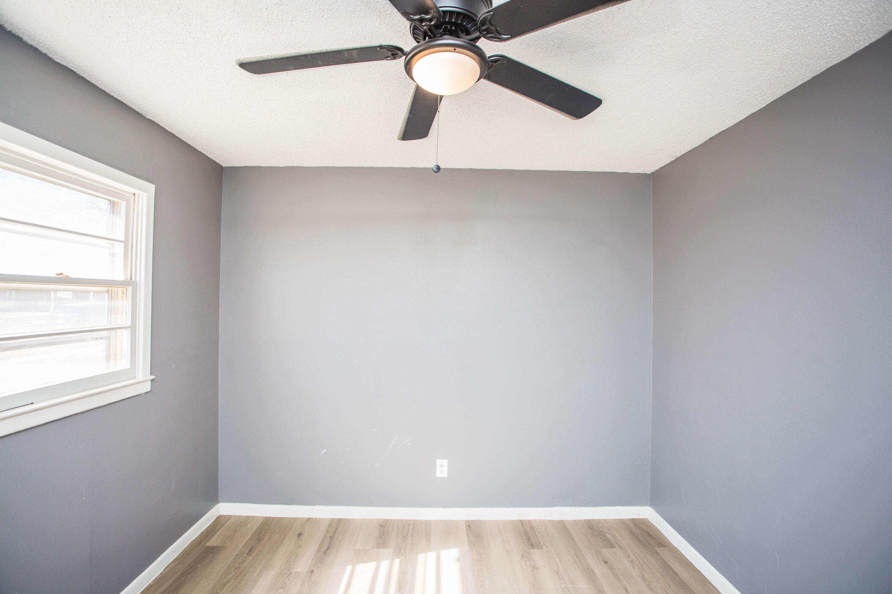 5212 41st Street Lubbock, TX 79414 - Photo 22 of 35 wooden floor in an empty room with a window