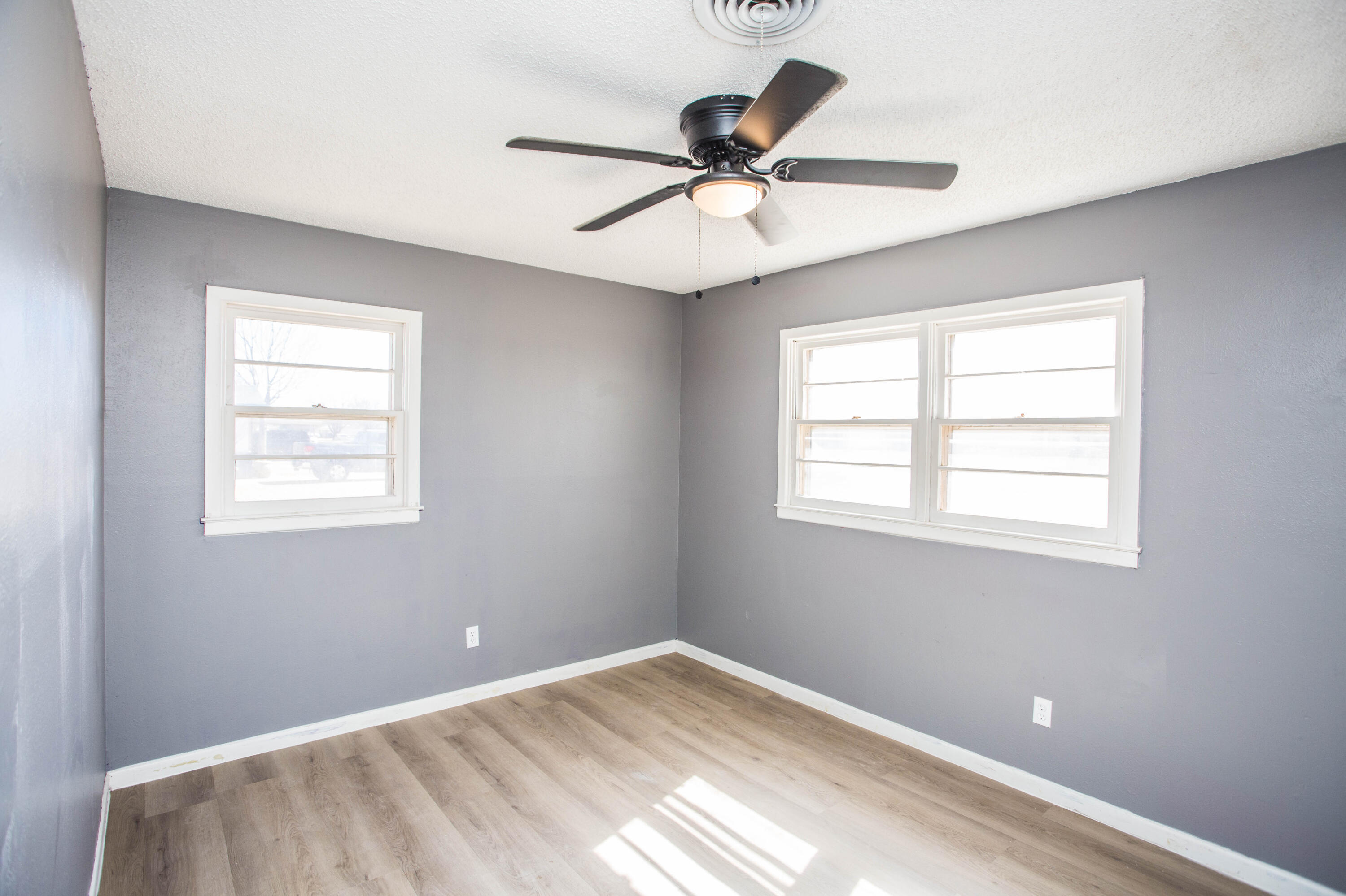 5212 41st Street Lubbock, TX 79414 - Photo 25 of 35 a view of a big room with wooden floor and windows