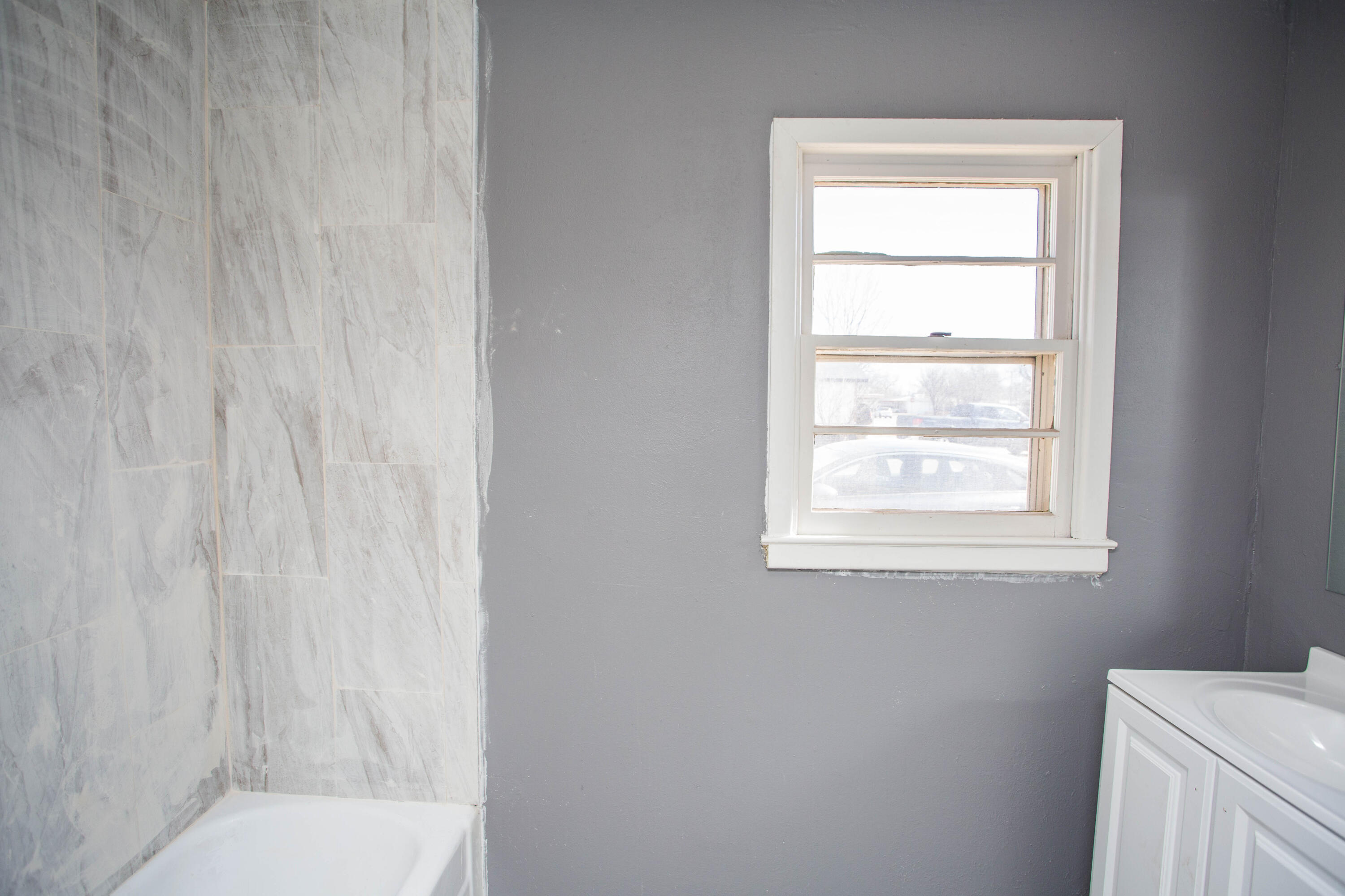 5212 41st Street Lubbock, TX 79414 - Photo 28 of 35 a bathroom with a window toilet and shower