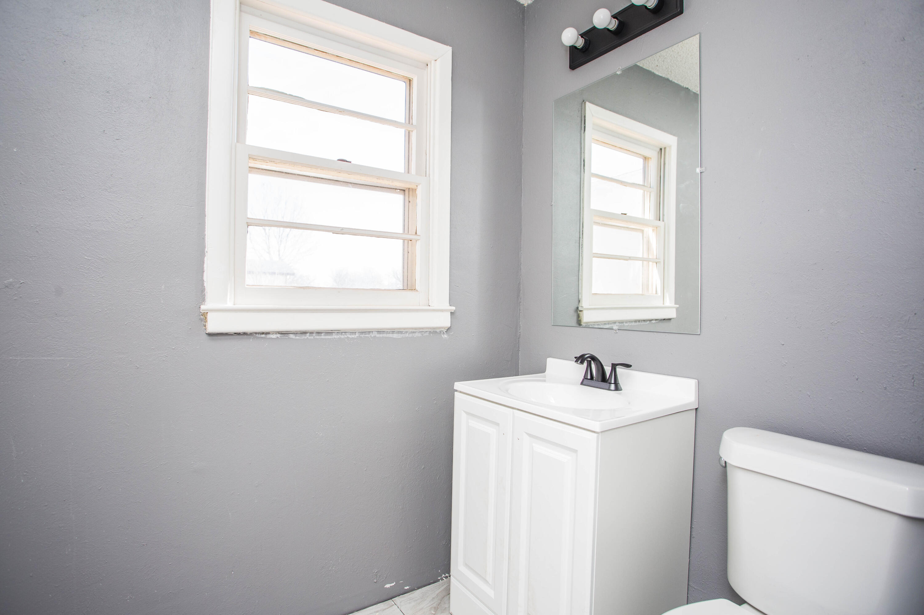 5212 41st Street Lubbock, TX 79414 - Photo 29 of 35 a view of bathroom with a sink toilet and a window