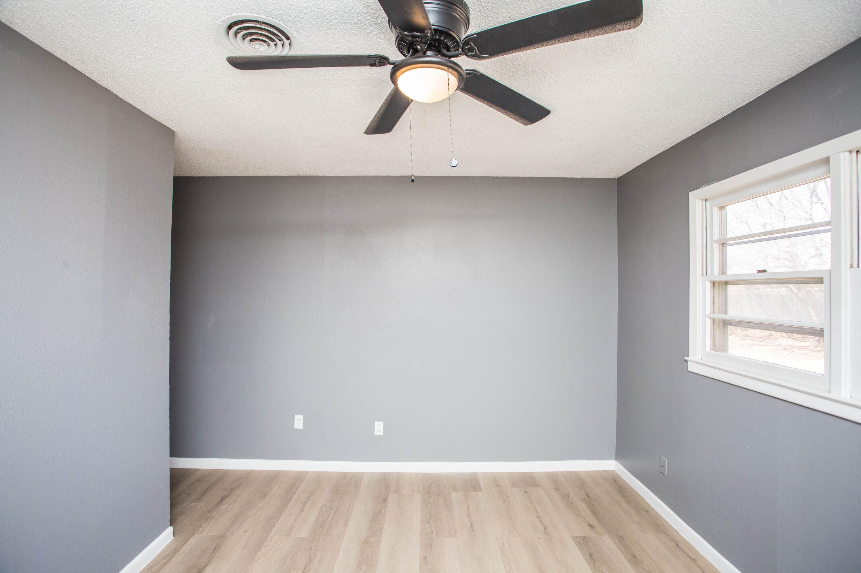 5212 41st Street Lubbock, TX 79414 - Photo 30 of 35 an empty room with a window and a ceiling fan