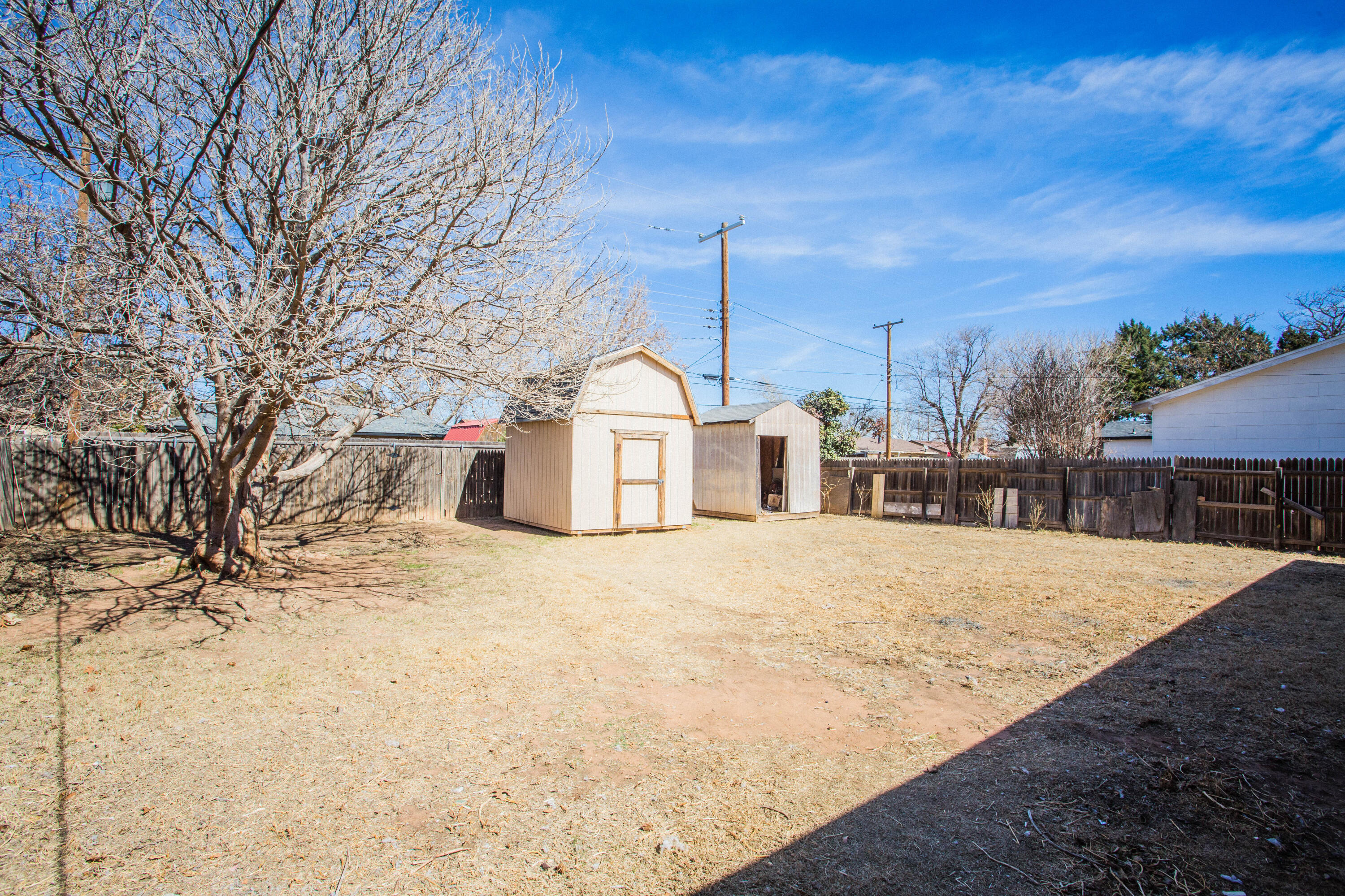 5212 41st Street Lubbock, TX 79414 - Photo 33 of 35 a wooden bench sitting in middle of a yard