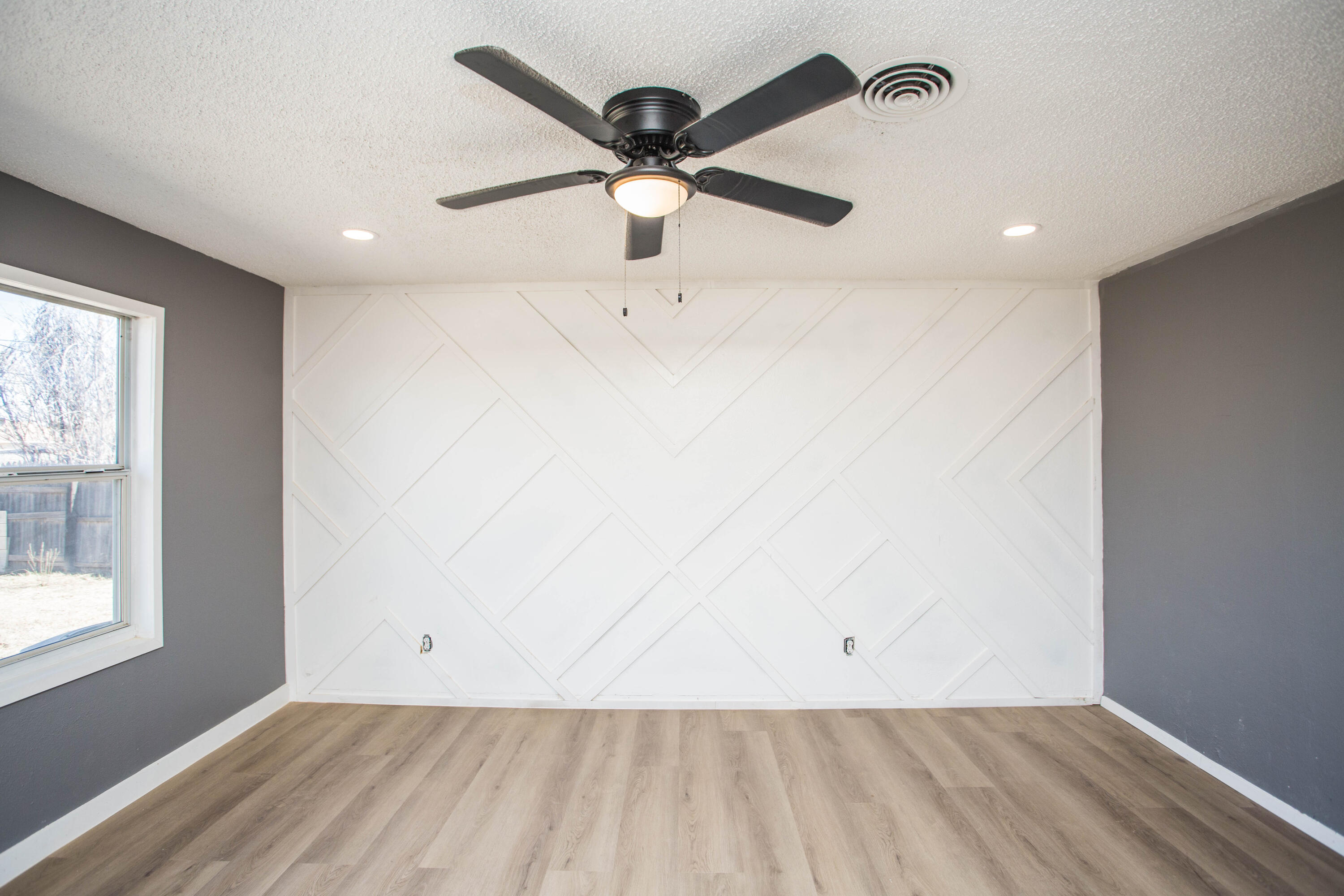 5212 41st Street Lubbock, TX 79414 - Photo 7 of 35 a view of empty room with wooden floor and fan