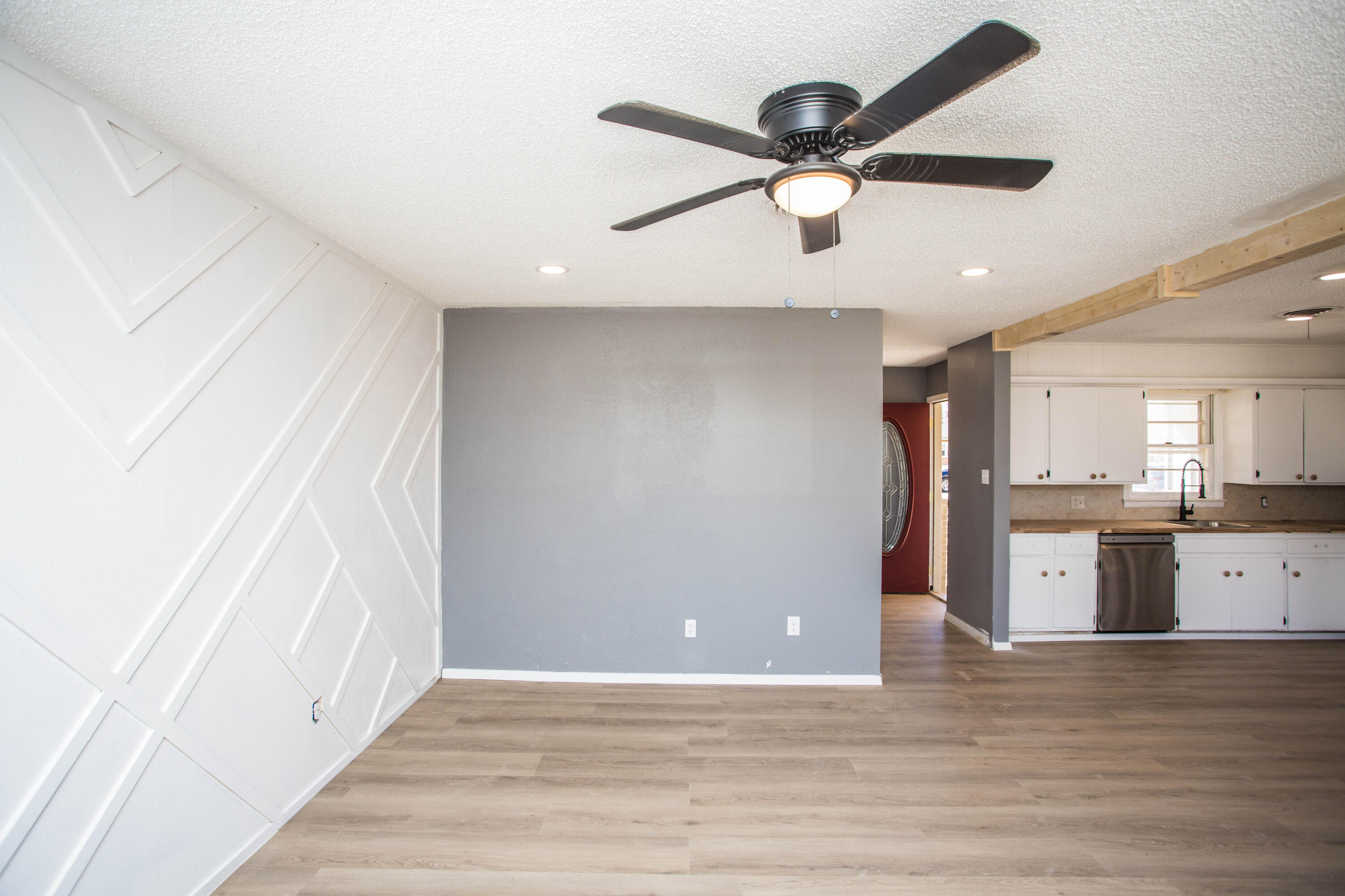 5212 41st Street Lubbock, TX 79414 - Photo 8 of 35 a view of an empty room with wooden floor and a ceiling fan