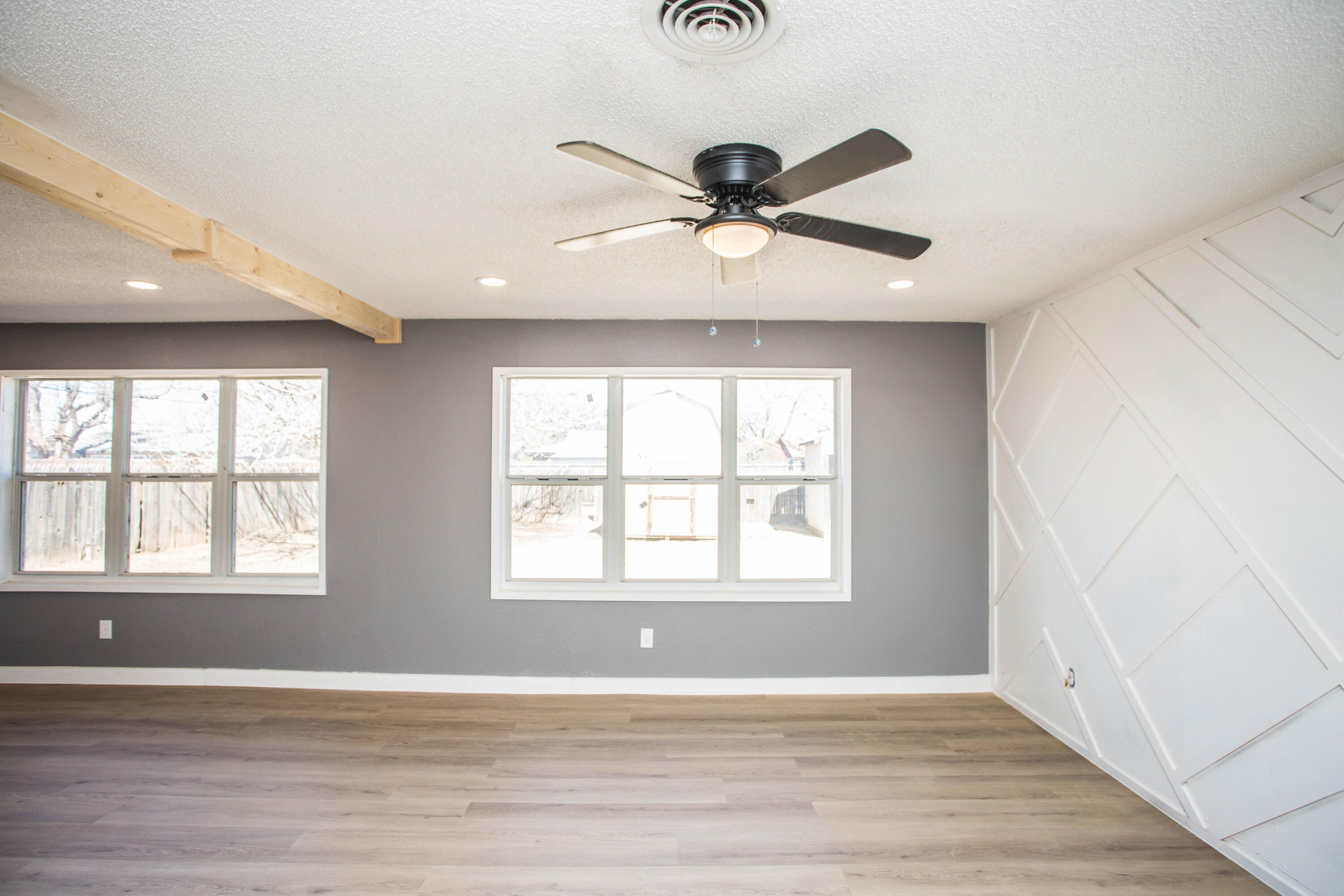 5212 41st Street Lubbock, TX 79414 - Photo 9 of 35 a view of an empty room with wooden floor and a window
