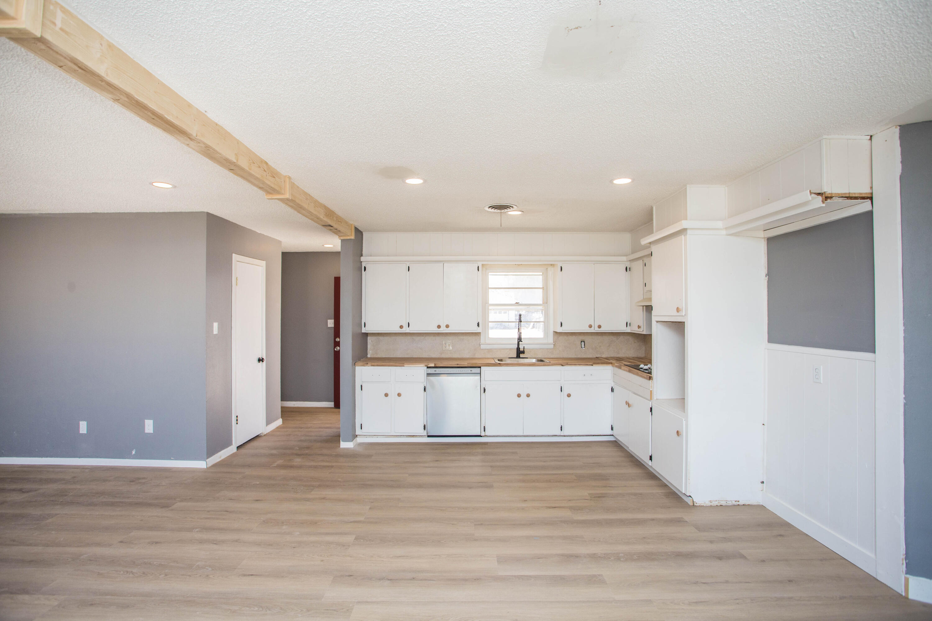 5212 41st Street Lubbock, TX 79414 - Photo 10 of 35 a kitchen with a sink cabinets and wooden floor