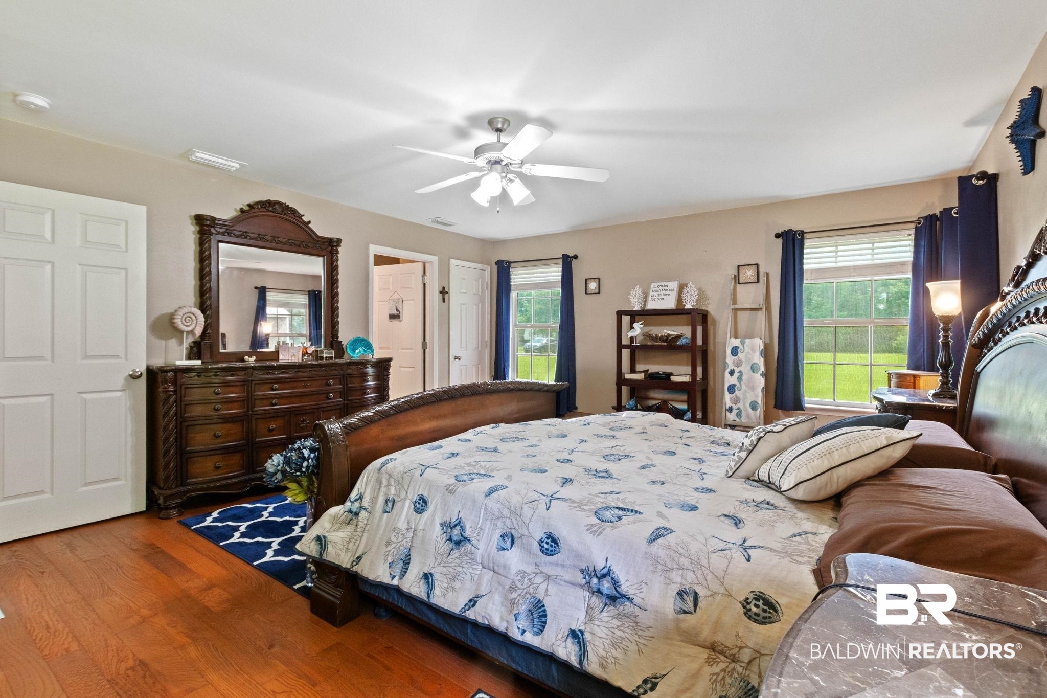 16151 Tolbert Road Bay Minette, AL 36507 - Photo 27 of 74 Spacious Primary bedroom featuring wood-finish flooring, a ceiling fan with integrated lighting, and neutral wall tones