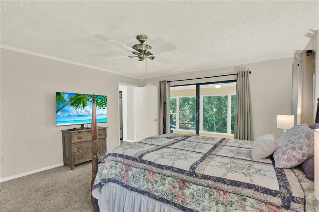5 Balsam Court South Homosassa, FL 34446 - Photo 12 of 35 a bedroom with a large bed and a flat screen tv