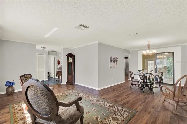 a dining room with furniture and wooden floor