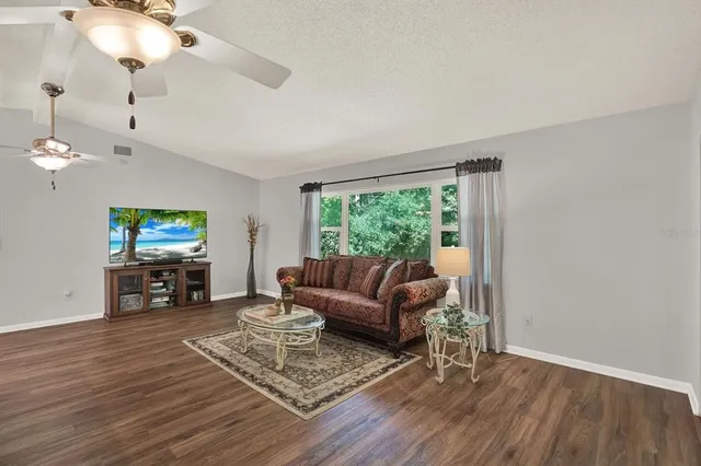 a living room with furniture a fireplace and a flat screen tv