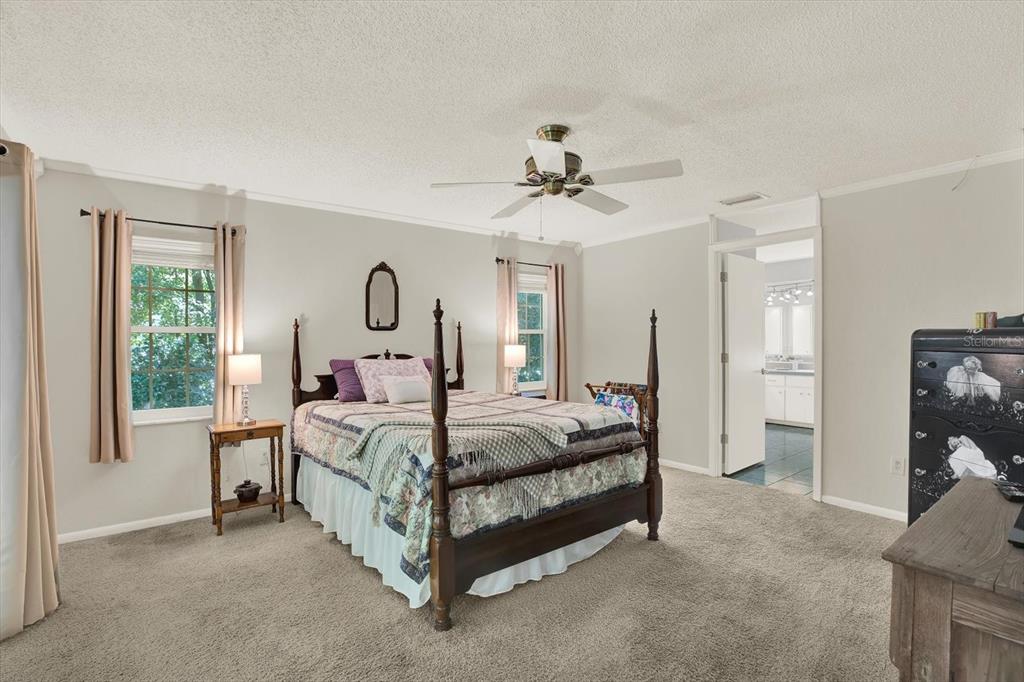 5 Balsam Court South Homosassa, FL 34446 - Photo 10 of 35 a bed room with a bed and a chandelier