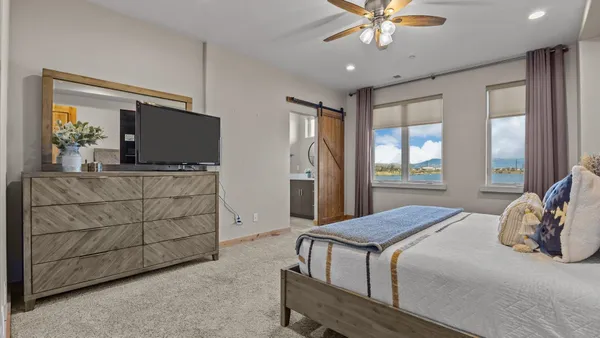 a bedroom with a bed and a flat screen tv