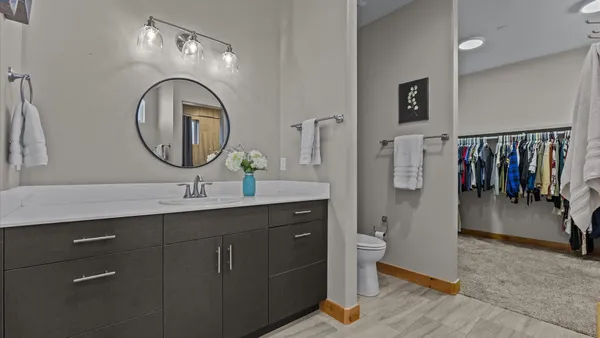 a bathroom with a toilet a sink and a mirror