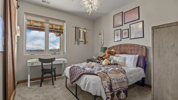 a bedroom with a large bed and a window