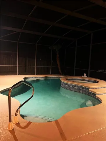 a view of a swimming pool with a yard