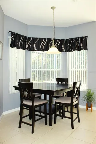 a dining room with a table and chairs