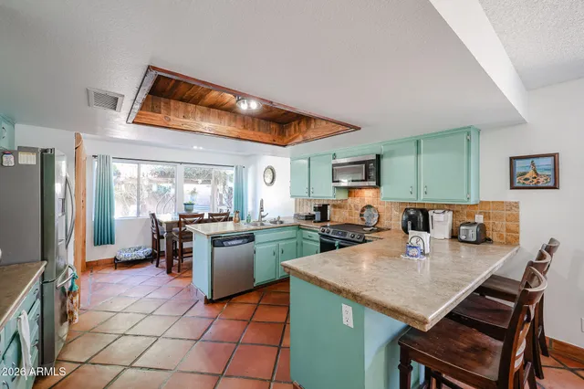 a kitchen with stainless steel appliances granite countertop a refrigerator and a stove