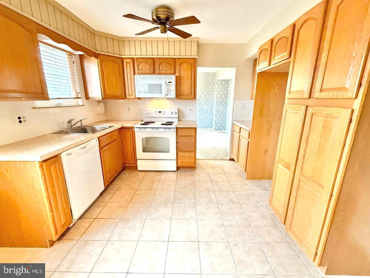 302 Provincetown Road Cherry Hill, NJ 08034 - Photo 2 of 30 a kitchen with stainless steel appliances a sink a stove a refrigerator and cabinets