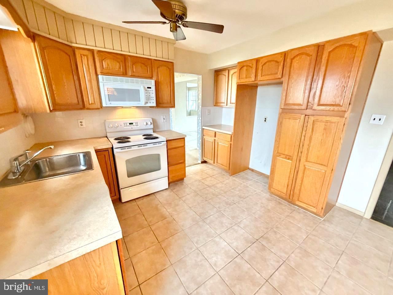 302 Provincetown Road Cherry Hill, NJ 08034 - Photo 3 of 30 a kitchen with stainless steel appliances granite countertop a stove a sink and a refrigerator