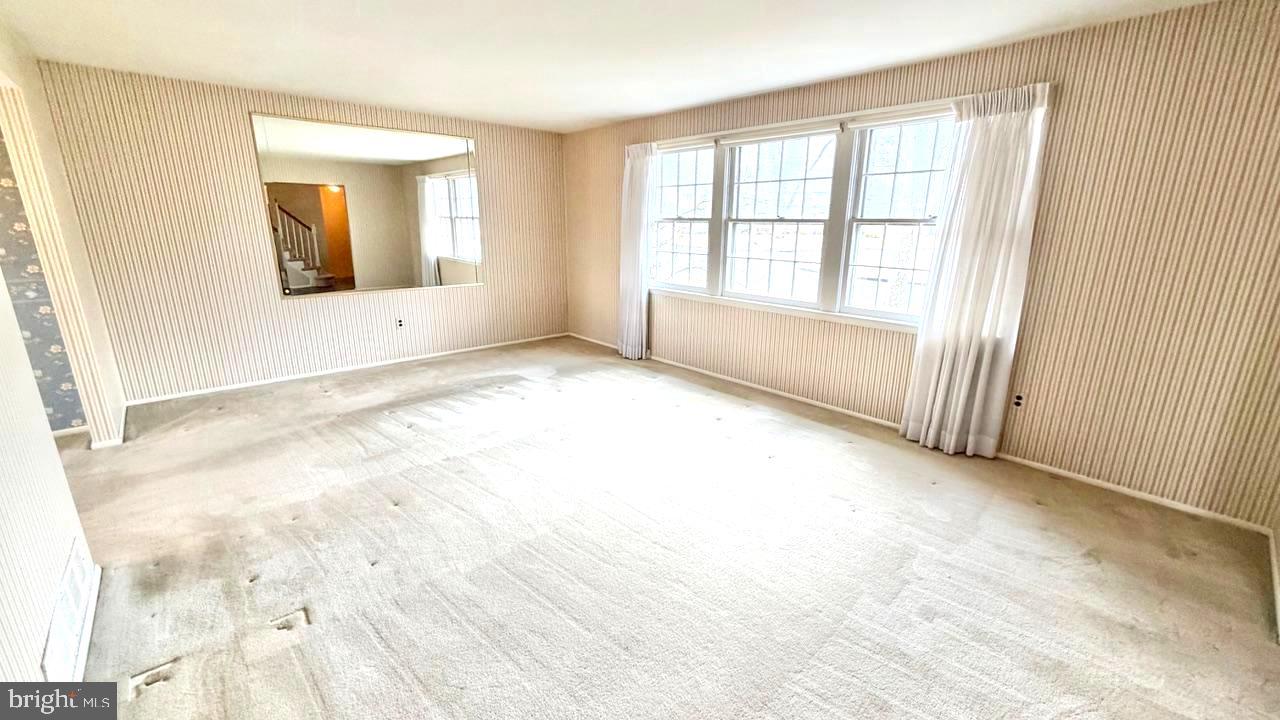 302 Provincetown Road Cherry Hill, NJ 08034 - Photo 7 of 30 an empty room with wooden floor and windows
