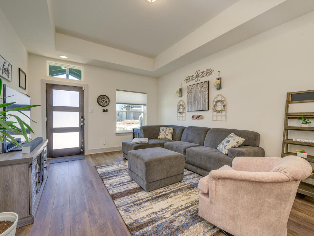 2257 Local Rebel Loop Leander, TX 78641 - Photo 8 of 26 a living room with furniture and a wooden floor