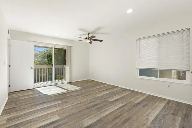 a view of a livingroom with a ceiling fan and window