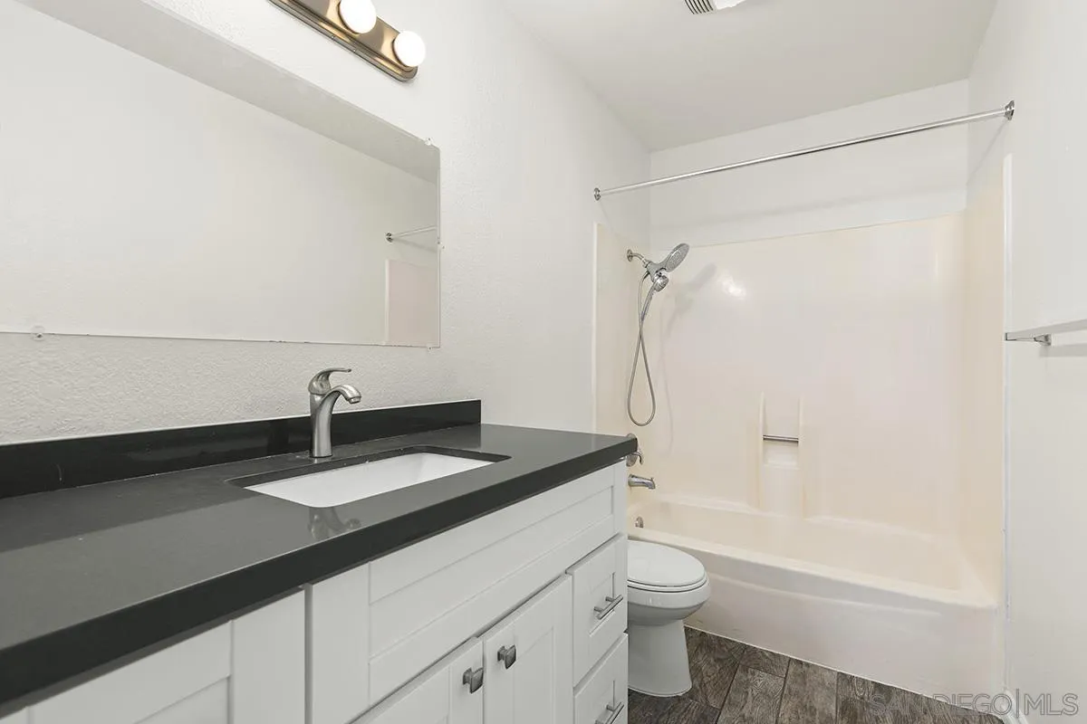 2511 Via Sorbete Carlsbad, CA 92010 - Photo 24 of 37 a bathroom with a granite countertop sink toilet and shower