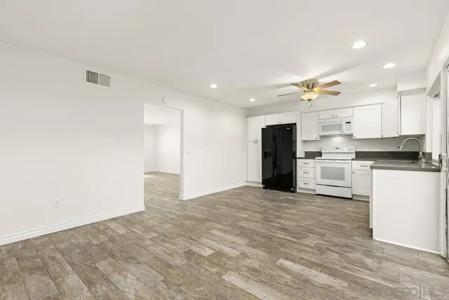 a view of a kitchen with a sink and stainless steel appliances