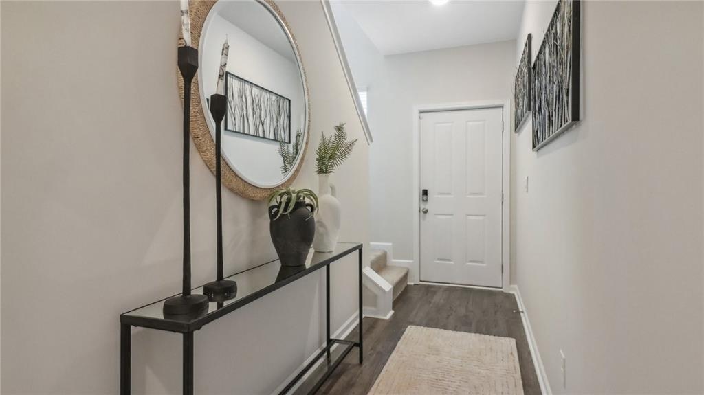2098 Moss Hill Road Stone Mountain, GA 30083 - Photo 11 of 40 a view of a hallway with wooden floor and staircase