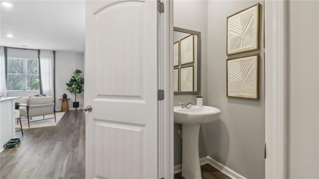 2098 Moss Hill Road Stone Mountain, GA 30083 - Photo 13 of 40 a bathroom with a sink a mirror and wooden floor