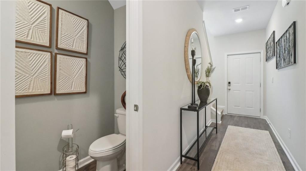 2098 Moss Hill Road Stone Mountain, GA 30083 - Photo 14 of 40 a bathroom with a toilet a sink and a mirror
