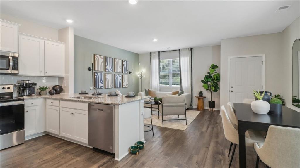 2098 Moss Hill Road Stone Mountain, GA 30083 - Photo 25 of 40 a large white kitchen with a table and chairs in it