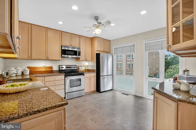 a kitchen with a refrigerator and a sink