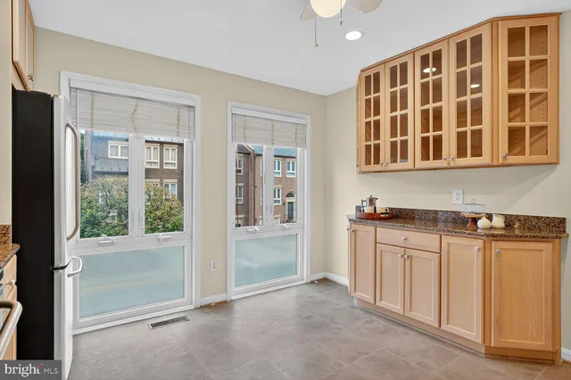 a view of kitchen with stainless steel appliances granite countertop cabinets and a refrigerator