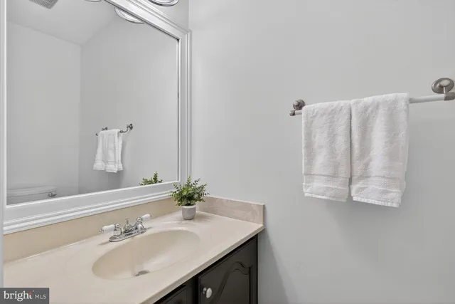 a bathroom with a sink vanity and a mirror