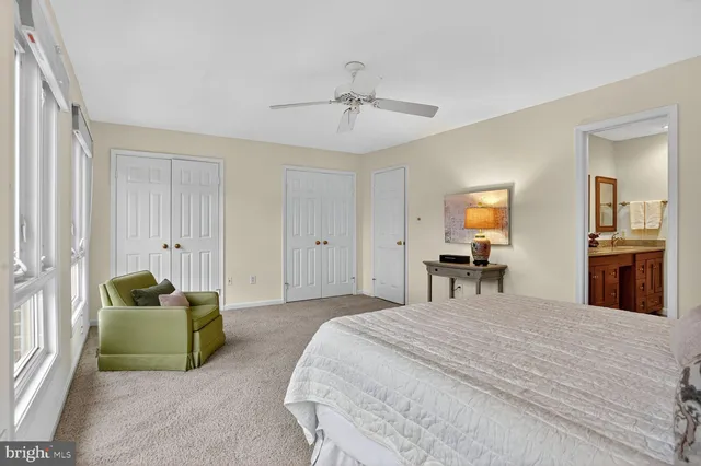 a bedroom with a bed and ceiling fan