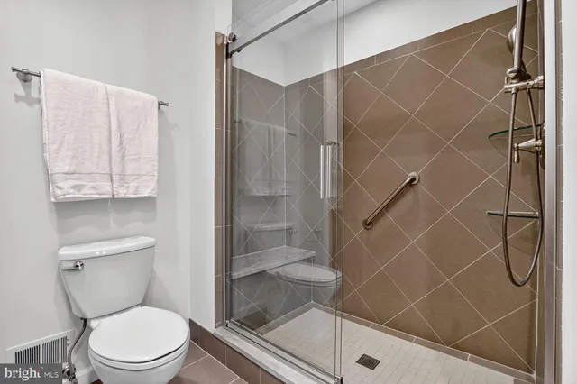 a white toilet and shower