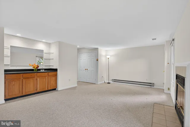 a view of an empty room with a kitchen