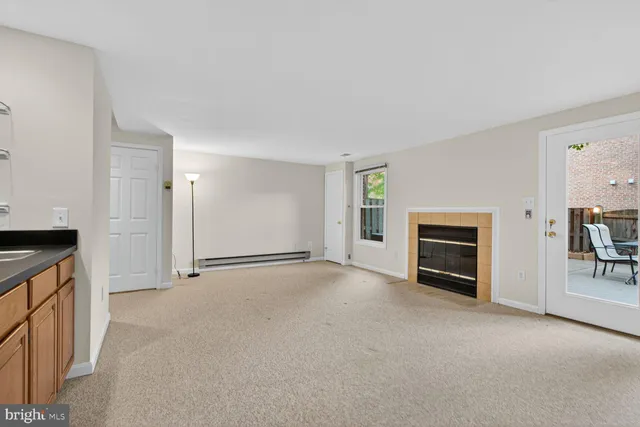 a view of empty room with a fireplace
