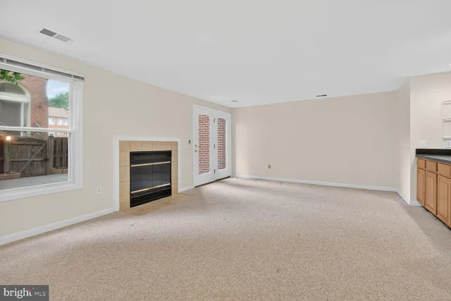 a view of empty room with a fireplace