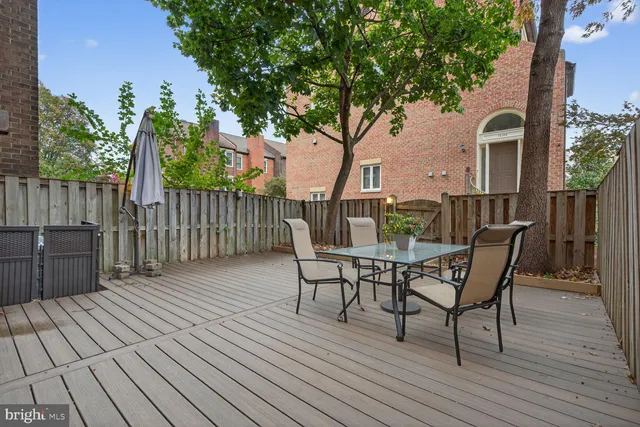 a view of a roof deck with table and chairs and wooden floor