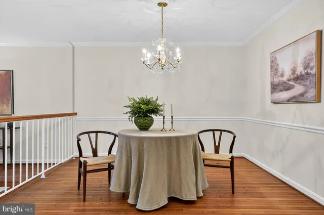 a view of a dining room with furniture wooden floor and a chandelier