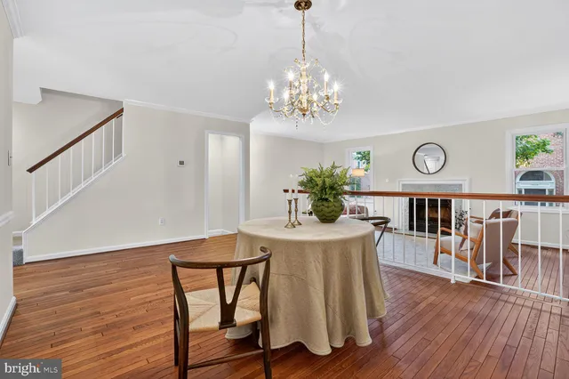 a view of a dining room with furniture wooden floor and chandelier