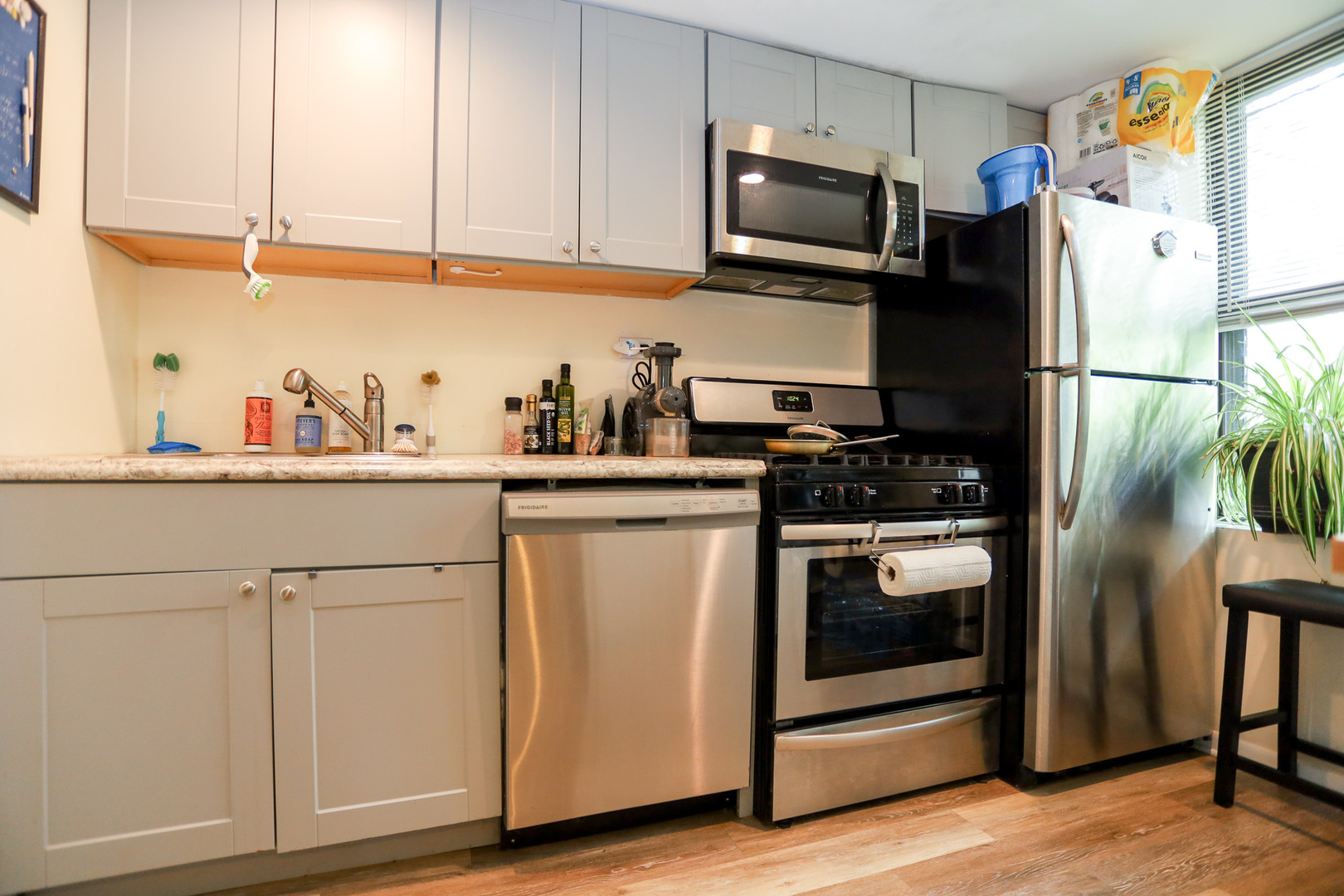 2325 West Addison Street, Unit 3 Chicago, IL 60618 - Photo 2 of 12 a kitchen with stainless steel appliances white cabinets and a refrigerator