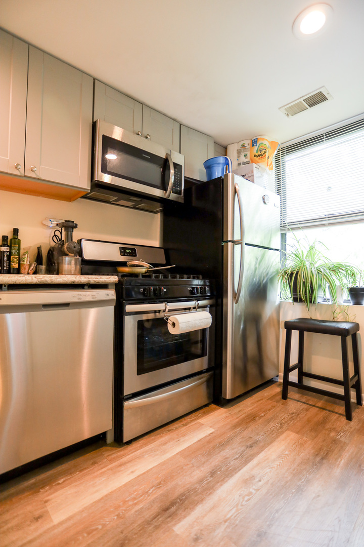 2325 West Addison Street, Unit 3 Chicago, IL 60618 - Photo 3 of 12 a kitchen with stainless steel appliances a stove a sink and a refrigerator