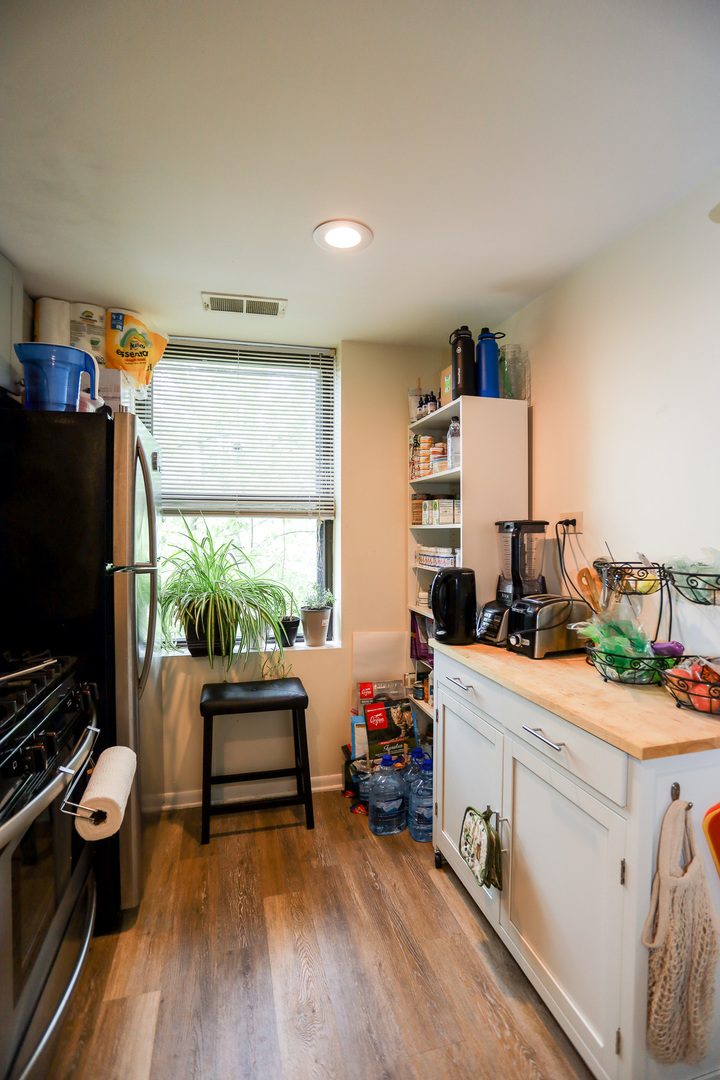 2325 West Addison Street, Unit 3 Chicago, IL 60618 - Photo 4 of 12 a room with furniture and a flat screen tv